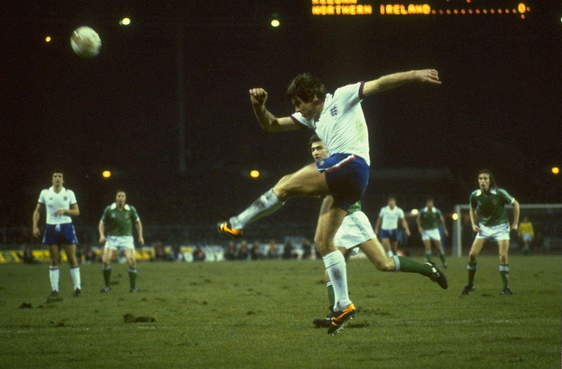 Emlyn Hughes of England clears the ball as Martin O''Neil of Northern Ireland looks on